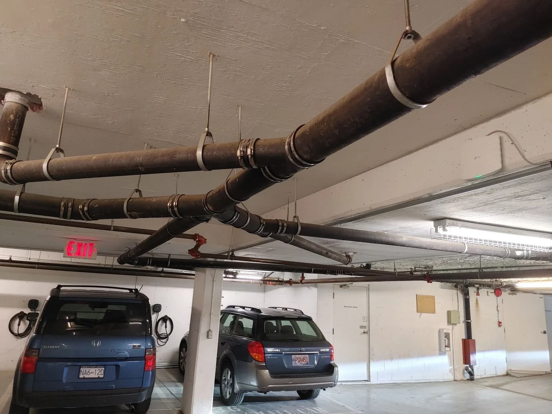 Overhead conduit, sprinkler services and lighting distribution in a commercial parkade