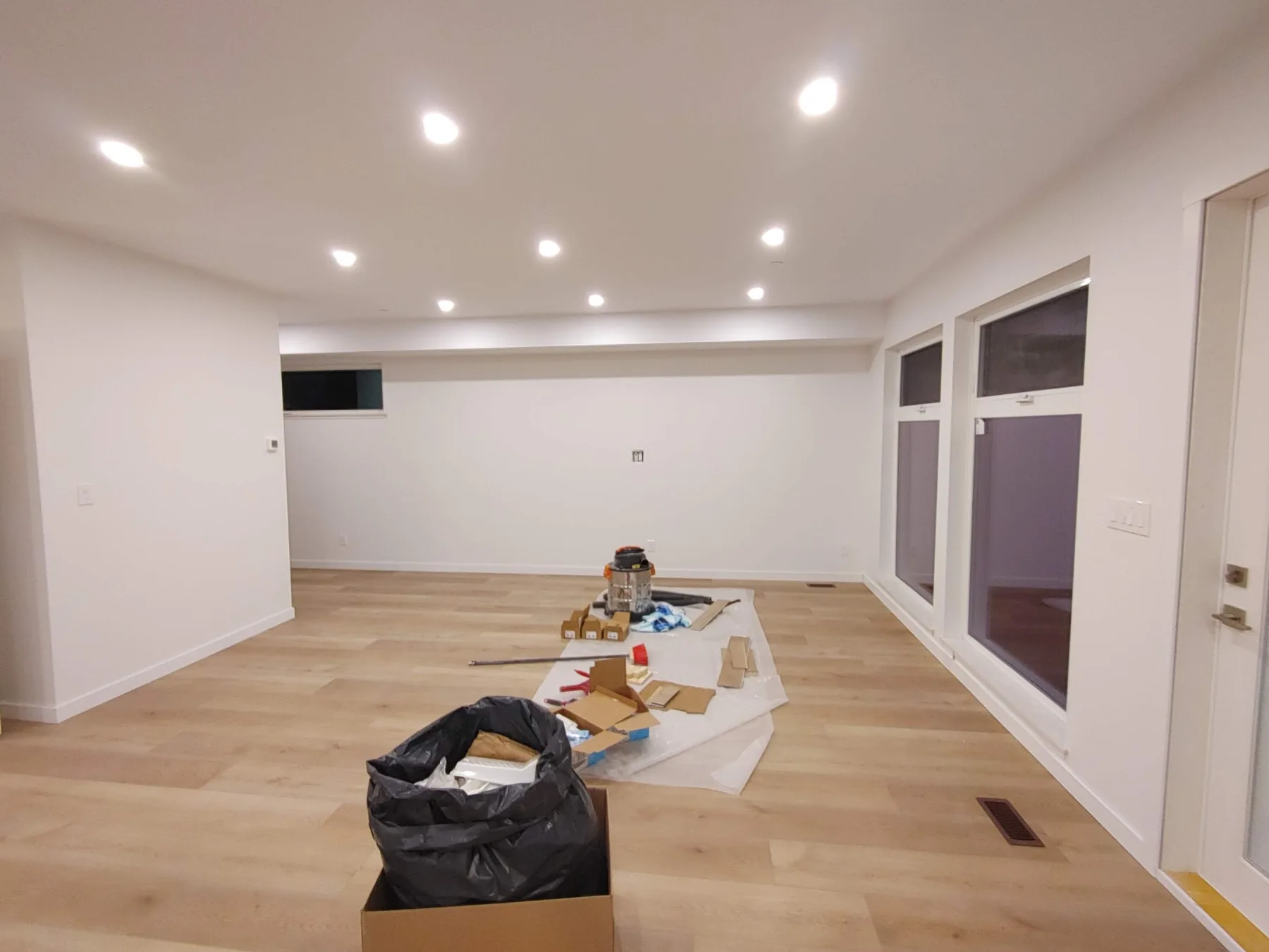 Recessed lighting illuminating a finished living room at night