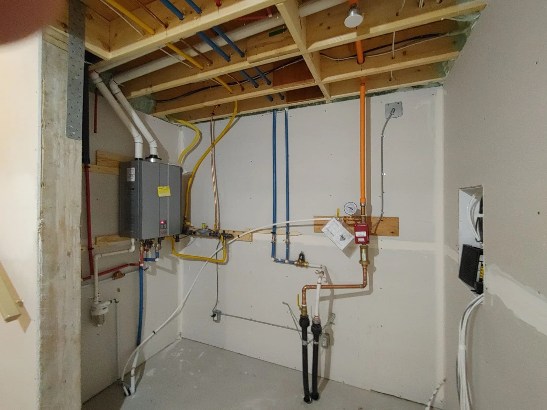 Service disconnect, conduit and tankless water-heater wiring in a residential mechanical room