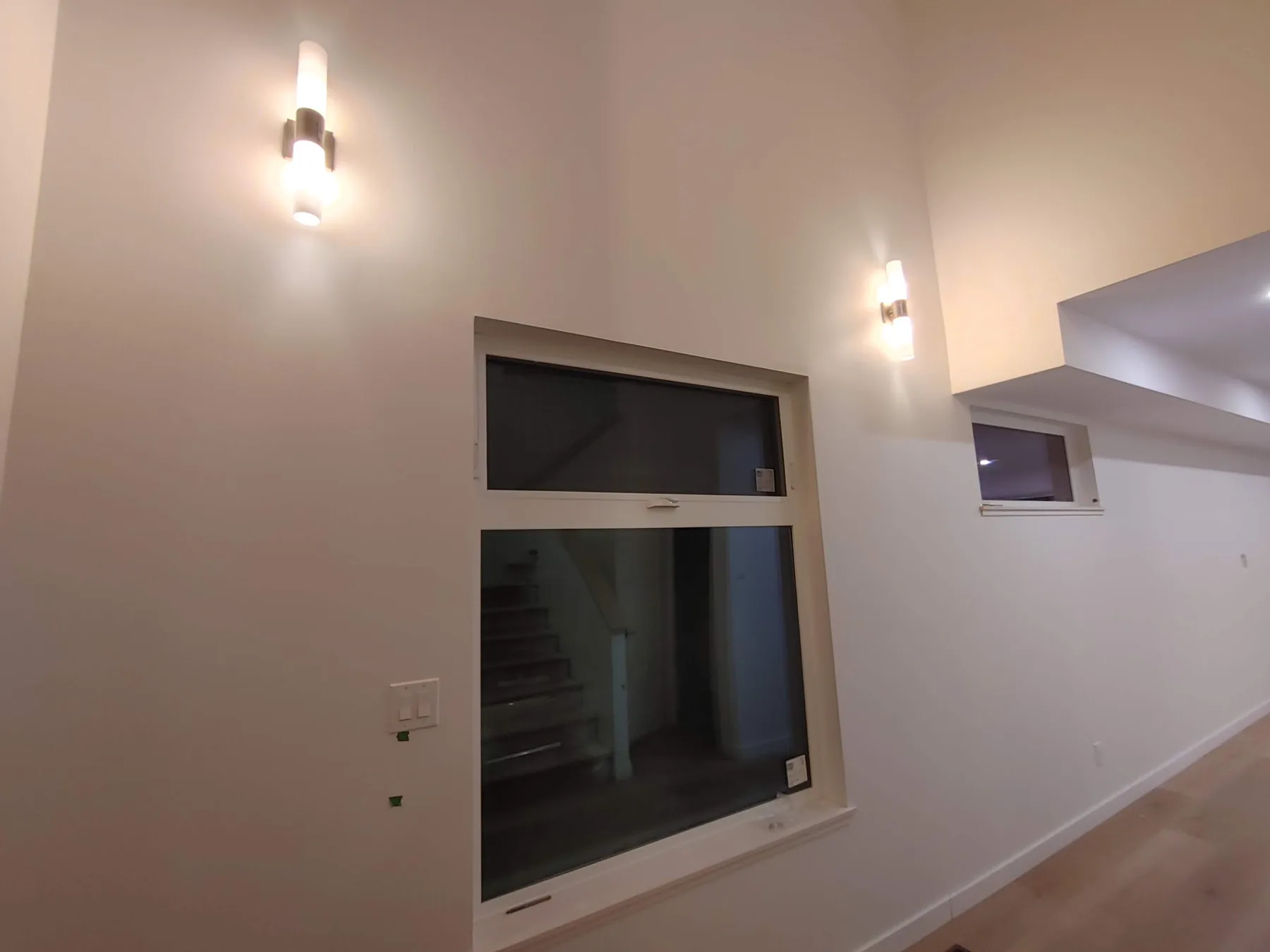 Wall sconces installed in a double-height stairwell