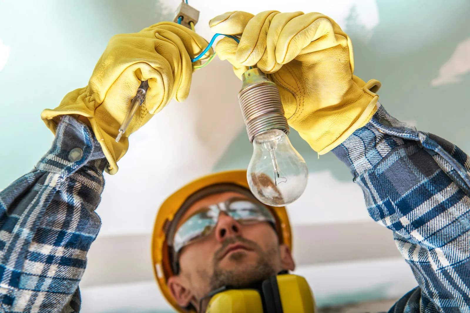 Lighting installation - electrician checking cables in a lighting system to fix a bug