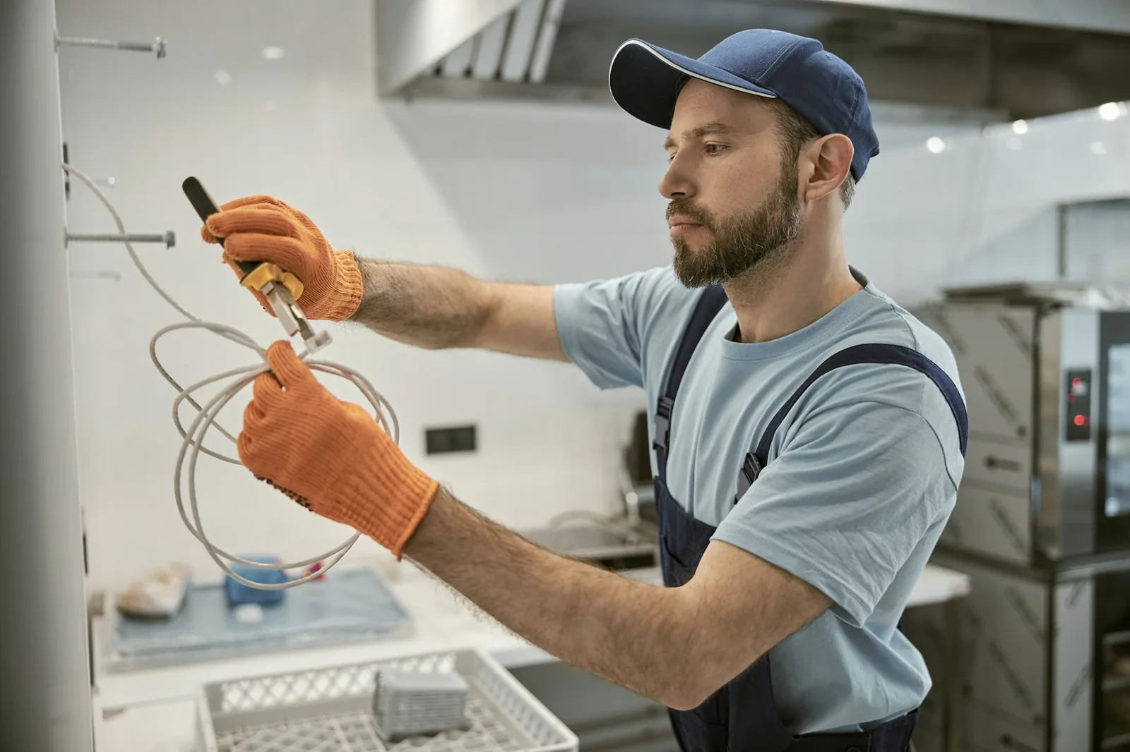 Residential wiring installation - male electrician repairing electric cable with pliers 1