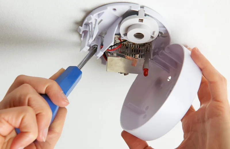 Electrician Burnaby installing the smoke detector